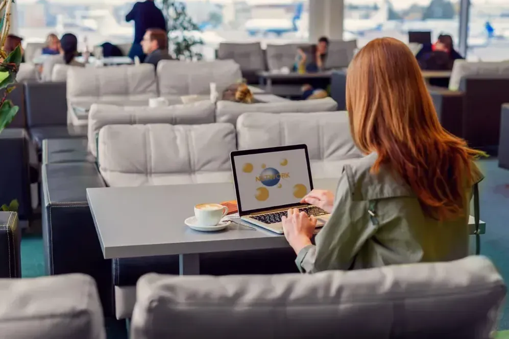 Woman connecting to airport wifi in an airport lounge