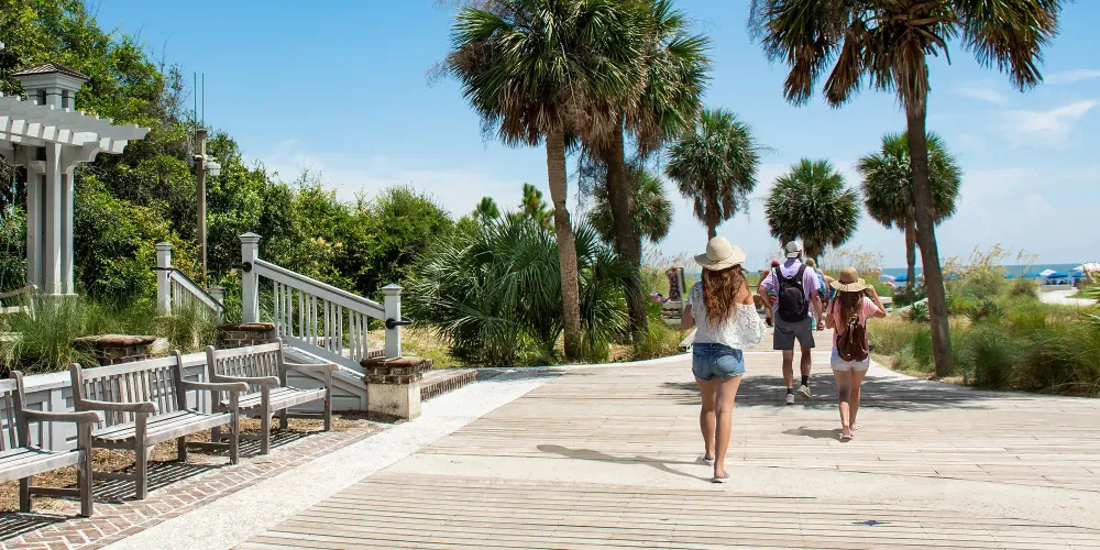 Family walking to the beach on summer vacation; Courtesy of margaret.wiktor/Shutterstock