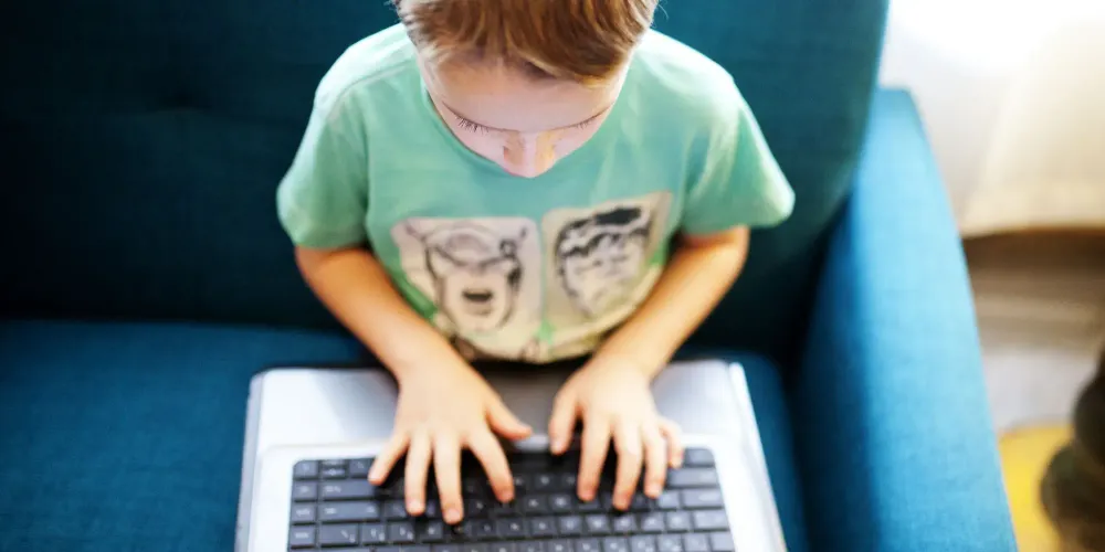 Boy playing on laptop; Courtesy of Twenty20