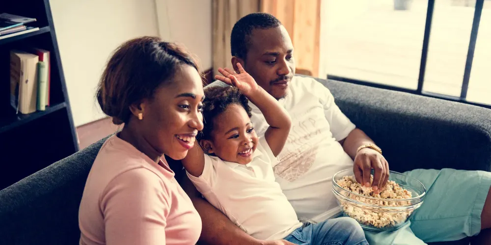 Family Watching Movie with Popcorn