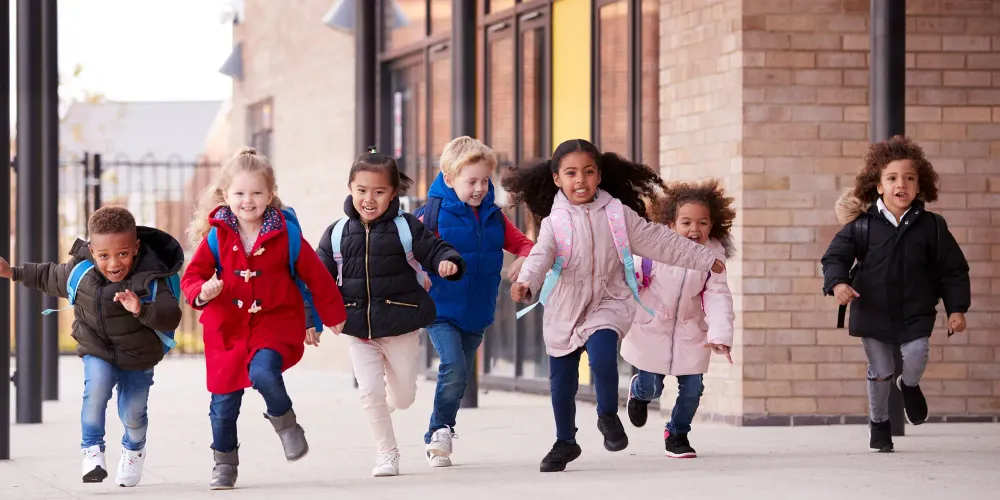 kids running wearing coats; Courtesy of Monkey Business Images /Shutterstock