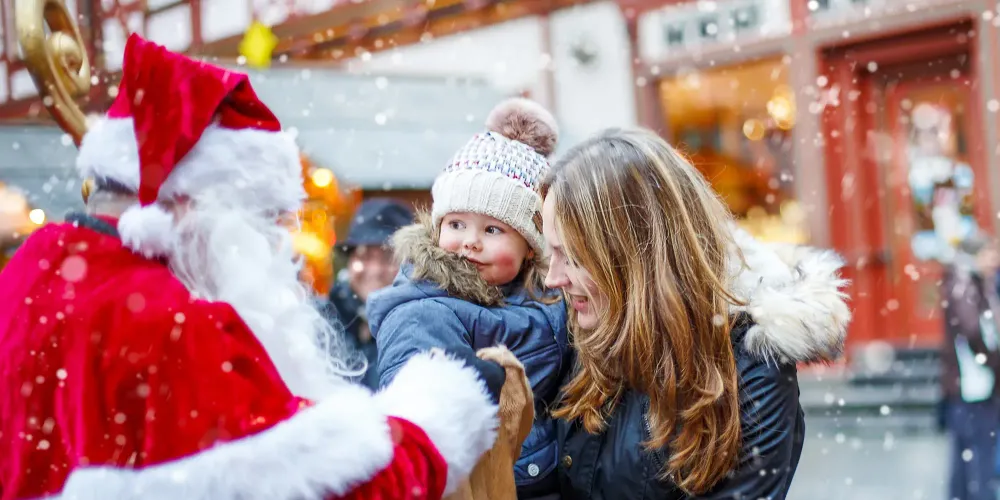 toddler mom christmas market santa; Courtesy of Romrodphoto /Shutterstock