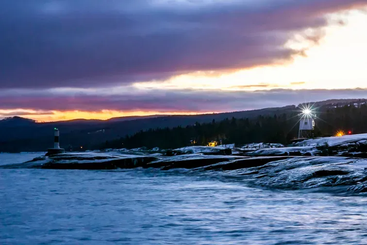 A Landscape Shot of the Grand Marais Lighthouse on Lake Superior in Northern Minnesota during a Dramatic Winter Sunset; Courtesy of Sam Wagner/Shutterstock