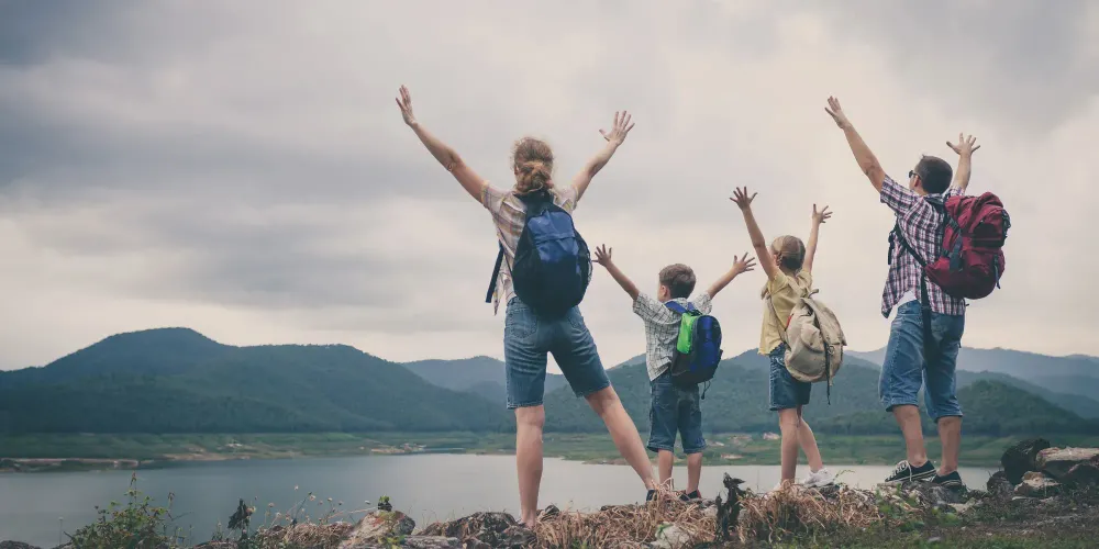 Family hiking with backpacks; Courtesy of altanaka/Shutterstock.com