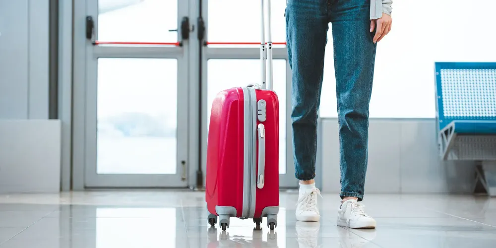 Woman Wearing Boyfriend Jeans at Airport; Courtesy of LightField Studios/Shutterstock.com