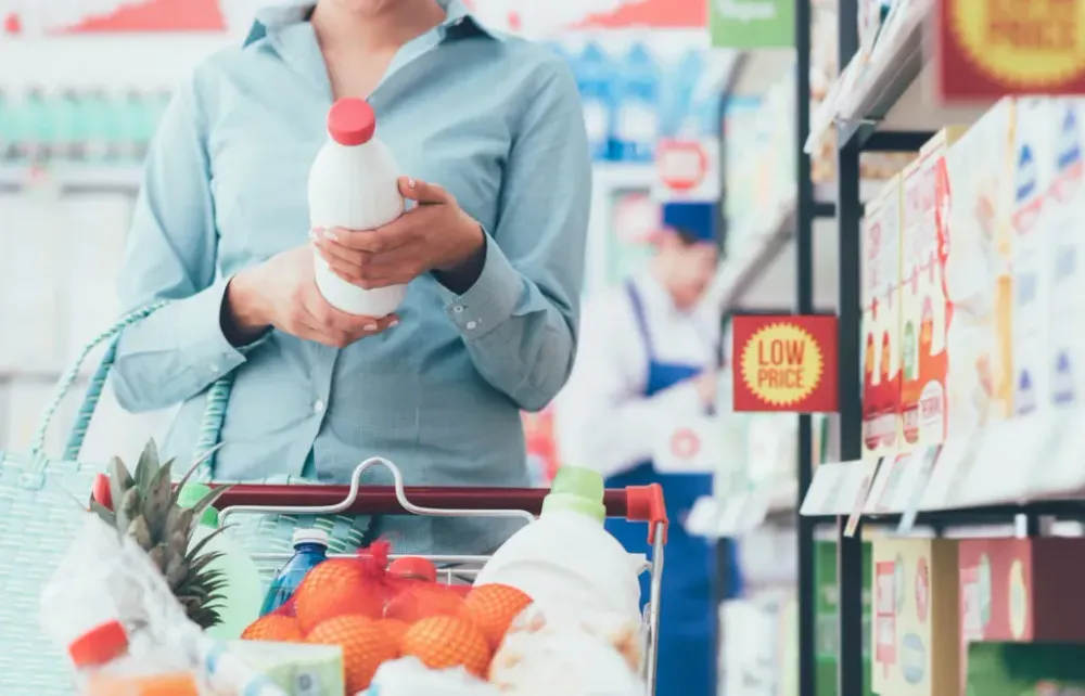 Woman reading ingredients label on bottle