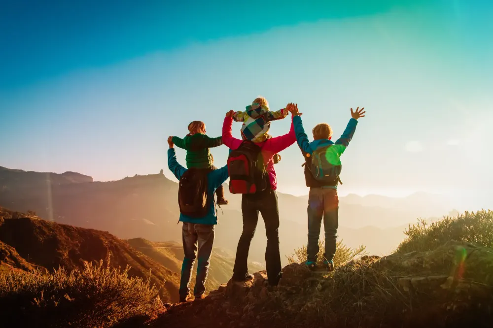Family in mountains at sunset