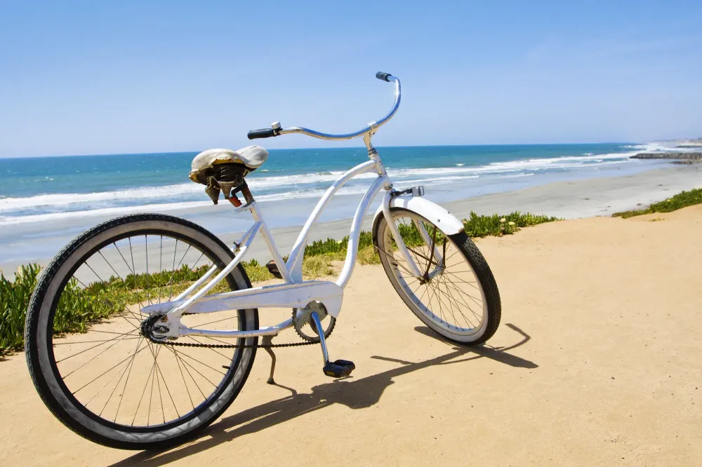 Bike in front of entrance to beach with ocean in background