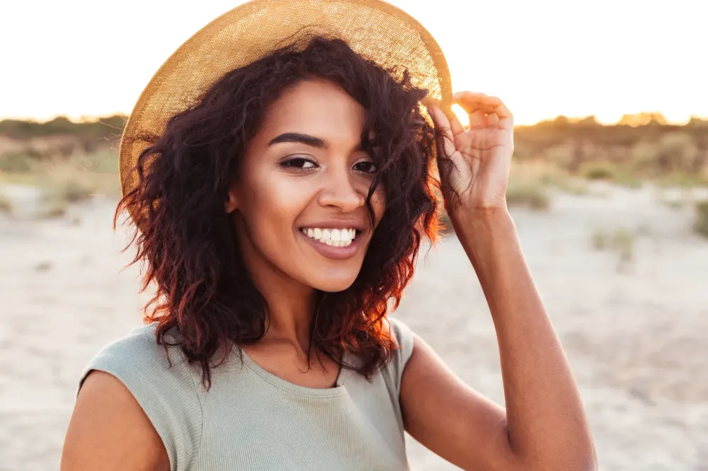 Woman smiling wearing a sun hat