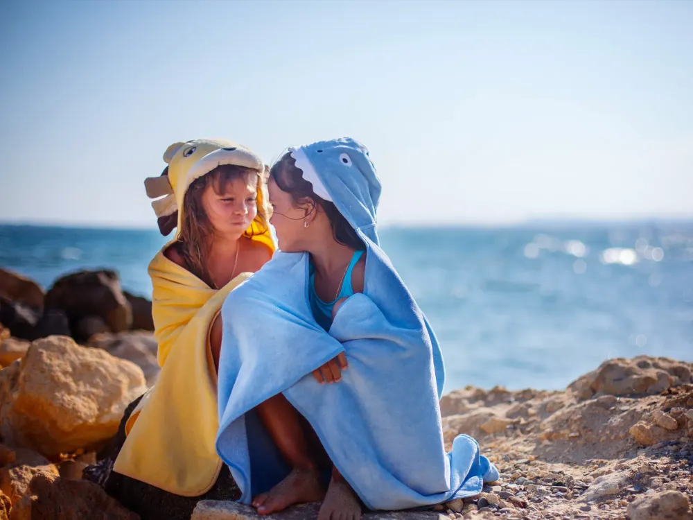 kids wearing beach towels; Courtesy of Kristina Zhuravleva/Shutterstock