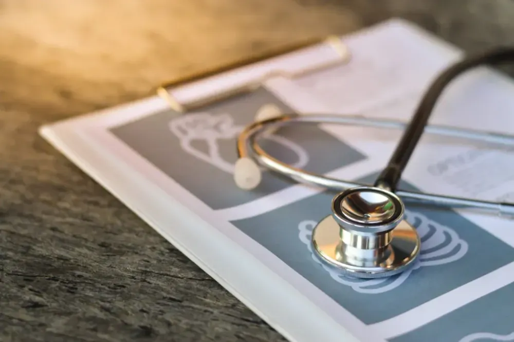 Stethoscope and pen on report pad