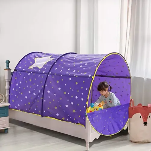 Child sitting on bed beneath Alvantor Starlight Bed Canopy