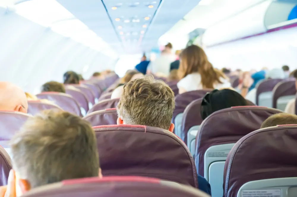 Passengers sit inside airplane - people traveling