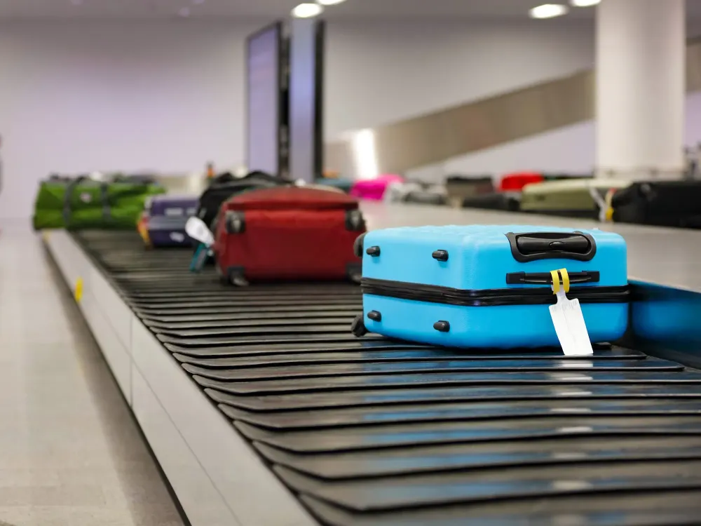 Suitcase or luggage on conveyor belt in the airport waiting