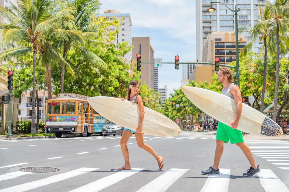 Surf Couple crossing street with surf boards