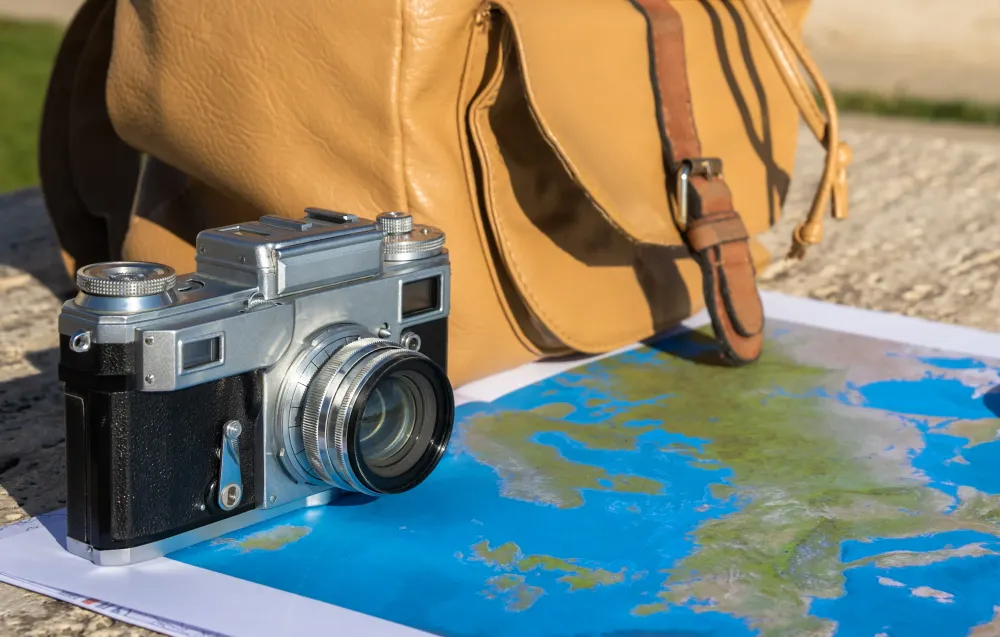 Camera and backpack on map