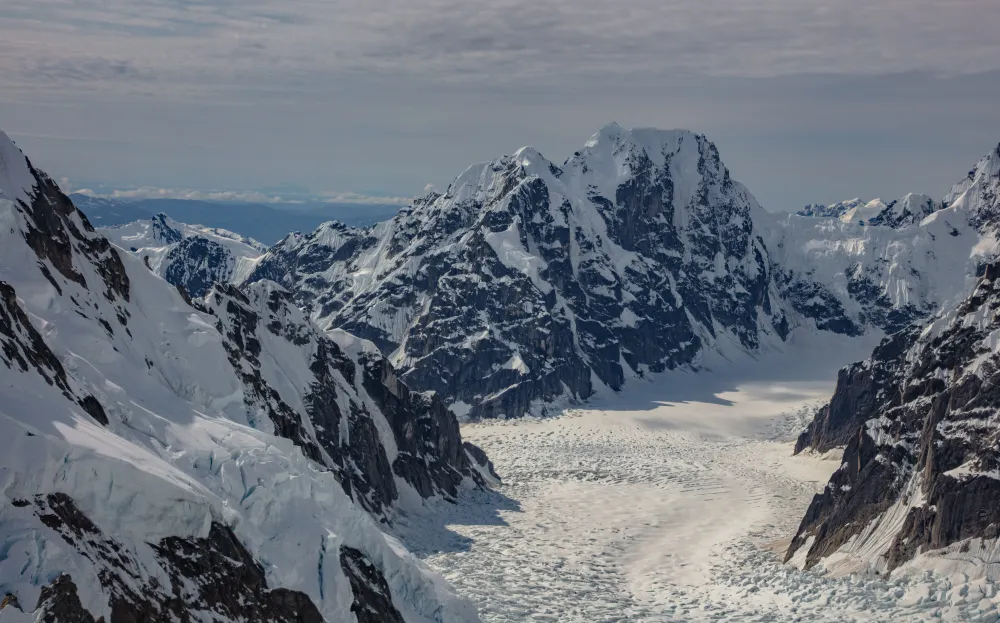 The mountains of the Alaska Range rise above a glacier. Captured on a flightseeing tour from Talkeetna Alaska.