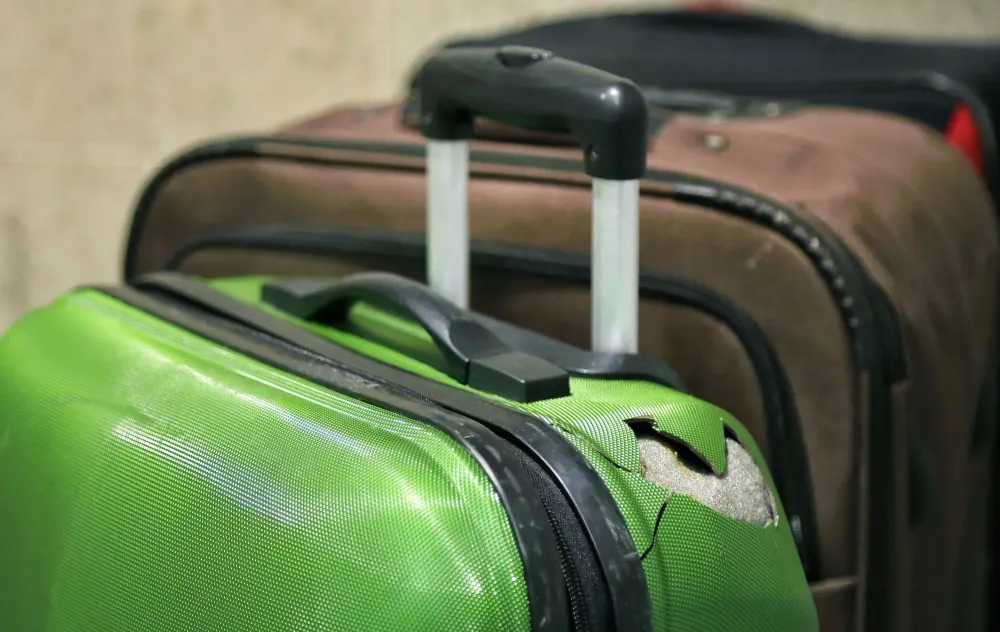 Mystery Solved: Here's Why Your Checked Luggage Gets so Beat-Up