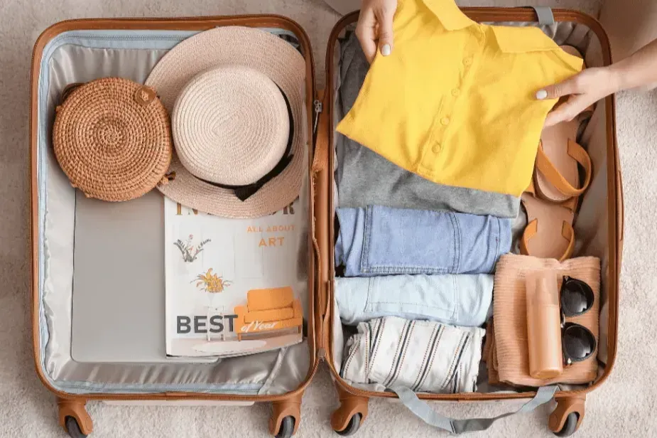 Woman packing suitcase at home. Travel concept